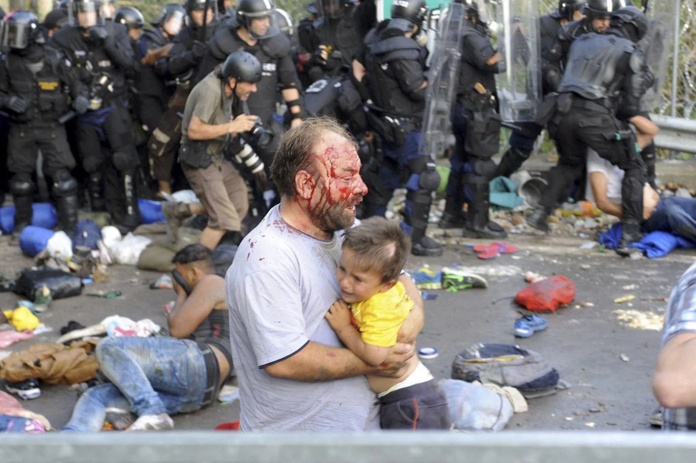 Hungarian policemen beat Syrian refugees in a file image. 